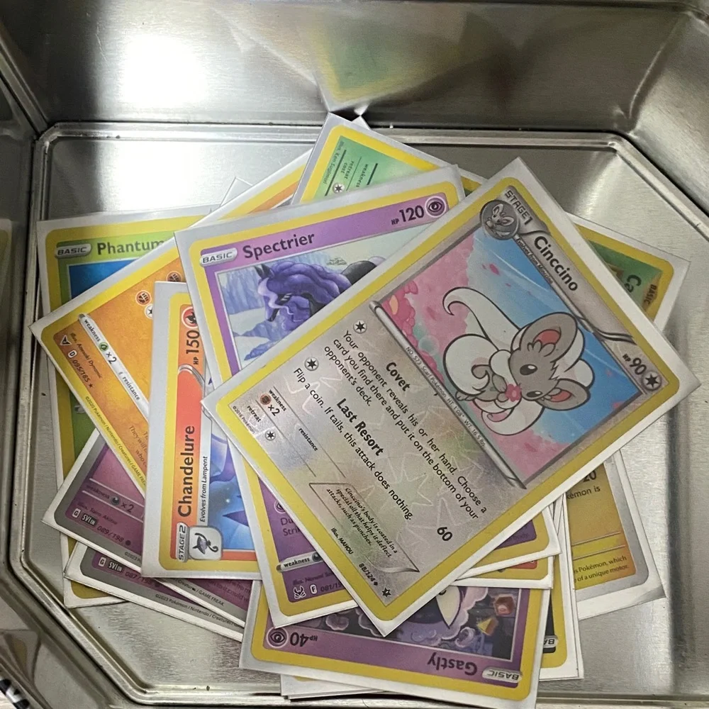 Pokemon Pikachu Yellow and Black Card Tin filled with cards and Pokémon pin